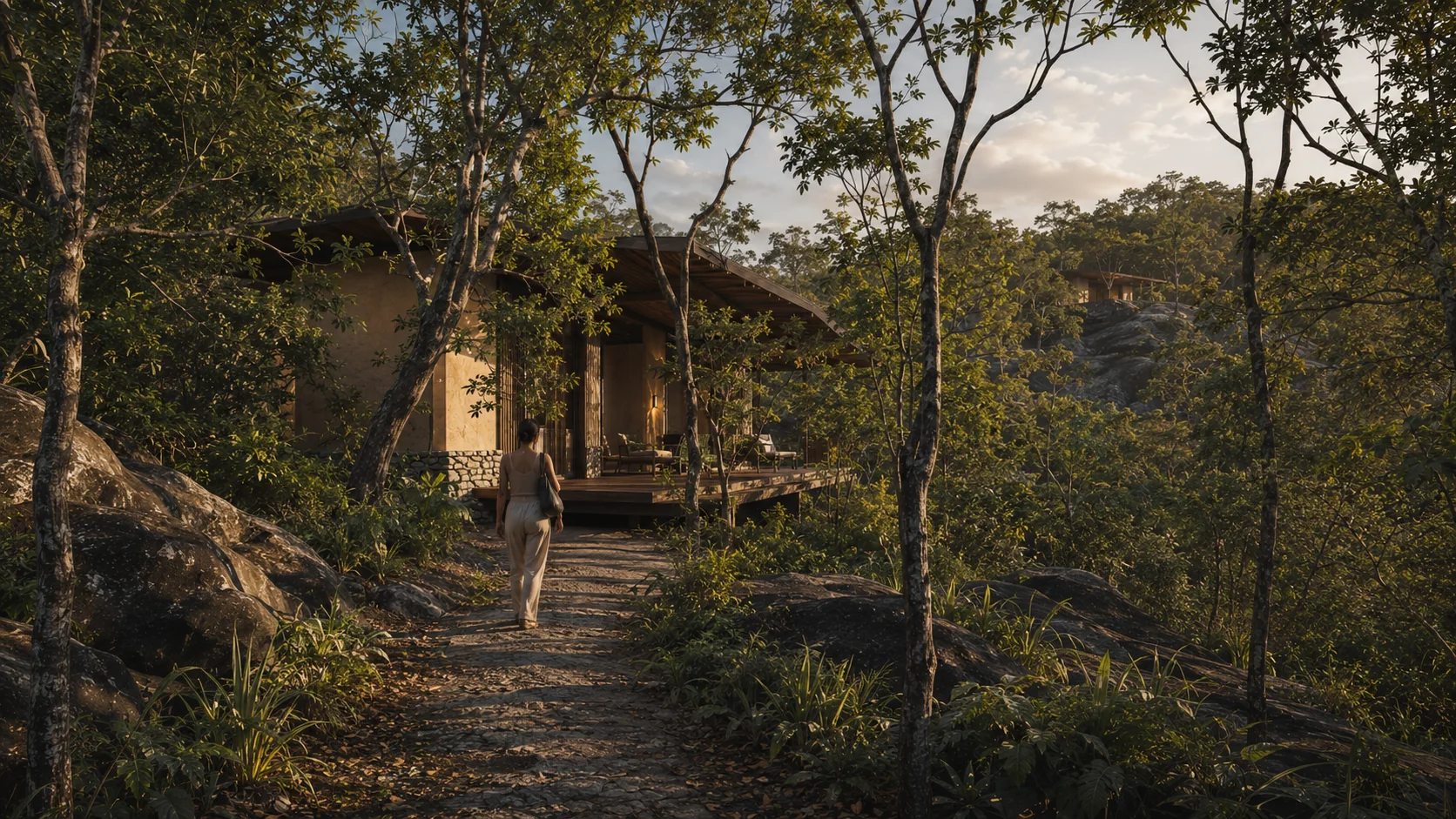 Cabana integrada à mata e às rochas na luz do fim da tarde